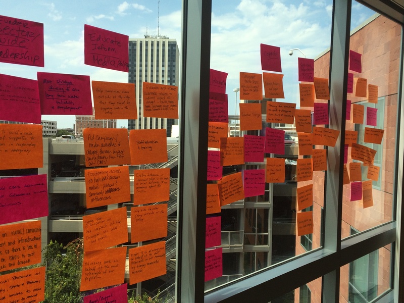 A conference room window is covered with sticky notes